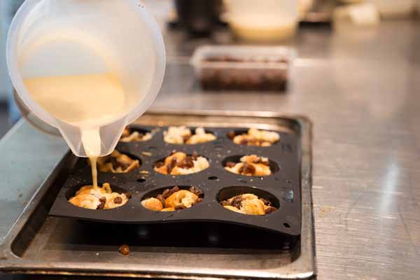 Pouring in custard make your own bread and butter pudding