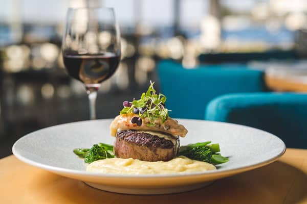 Image of Aqua Restaurant meal with glass of red wine