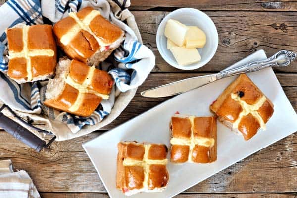 Hot Cross Buns on platter with butter and knife