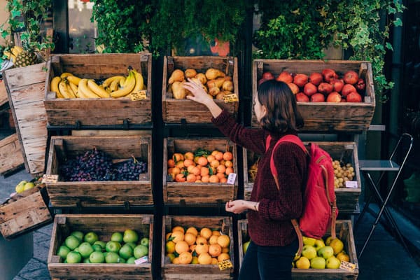 Photo of lady shopping at local markets, a trend we hope never goes out of fashion