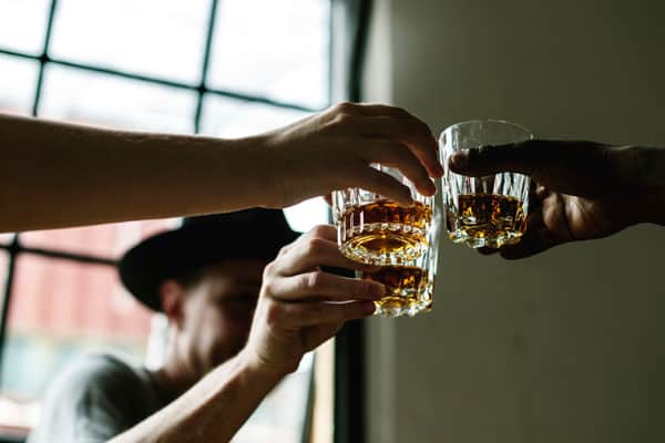 Image of people having whisky, a trend now back in fashion