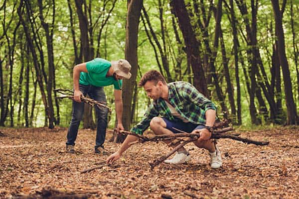 Photo of two men collecting wood for campfire