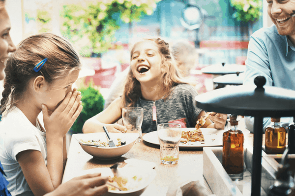 Photo of young girls laughing at a Dad joke