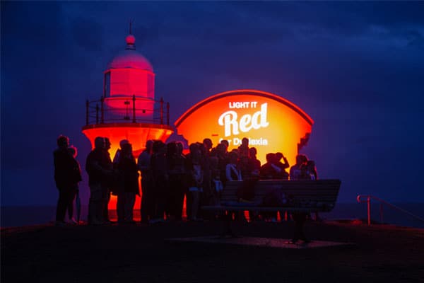 Photo of Tacking Point Lighthouse lit up as part of Light it Red for Dyslexia 2018